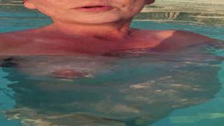 Exploring intimate desires, succumbing to aquatic pleasure, left phone submerged under waves