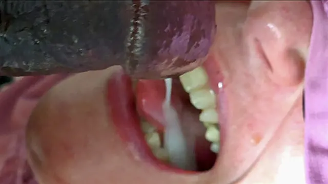 She′s got a black cock🌭 in her throat &mdash;  sucking on its juicy head